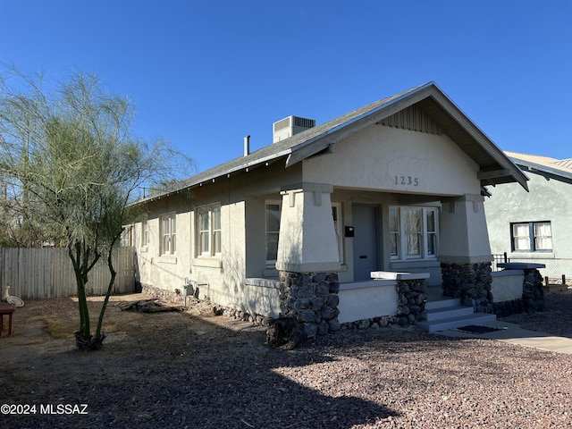 view of front of home with a porch and central air condition unit