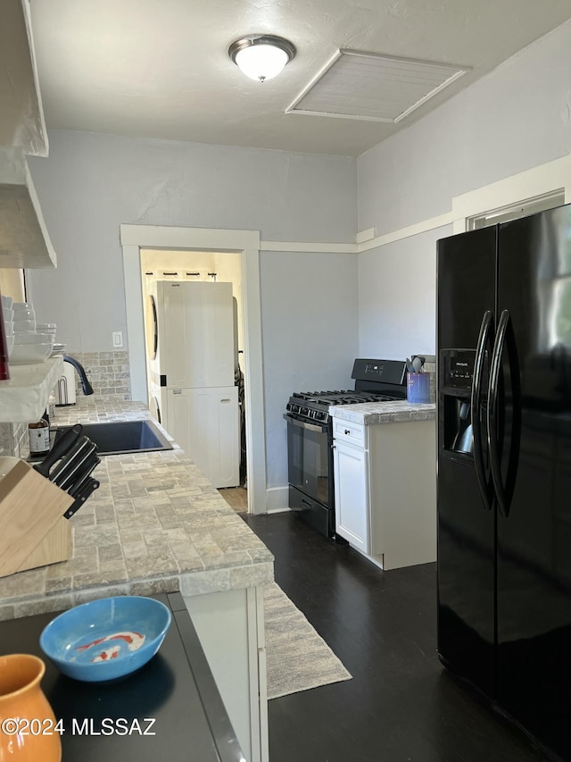 kitchen with white cabinets, dark hardwood / wood-style flooring, sink, and black appliances