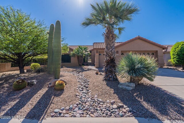 1474 N Miranda Ln, Green Valley, AZ 85614 - view of front of property featuring a tile roof, driveway, a garage, and stucco siding