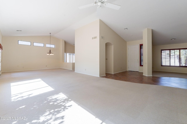 1474 N Miranda Ln, Green Valley, AZ 85614 - unfurnished living room with carpet flooring, a wealth of natural light, lofted ceiling, and ceiling fan with notable chandelier