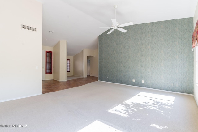 1474 N Miranda Ln, Green Valley, AZ 85614 - carpeted spare room featuring a ceiling fan, visible vents, arched walkways, wallpapered walls, and lofted ceiling