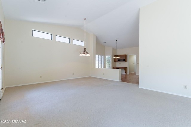 1474 N Miranda Ln, Green Valley, AZ 85614 - carpeted spare room featuring a chandelier, high vaulted ceiling, and baseboards