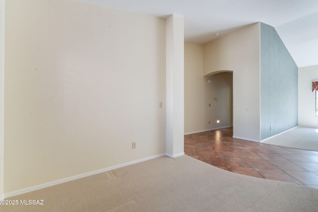 1474 N Miranda Ln, Green Valley, AZ 85614 - carpeted spare room with baseboards, arched walkways, and tile patterned flooring