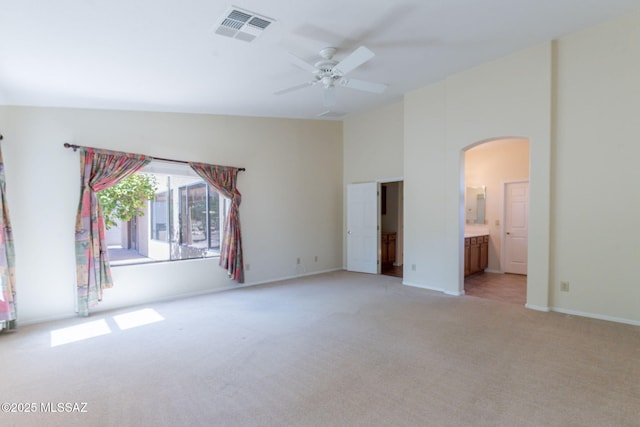 1474 N Miranda Ln, Green Valley, AZ 85614 - interior space with visible vents, baseboards, arched walkways, light carpet, and high vaulted ceiling