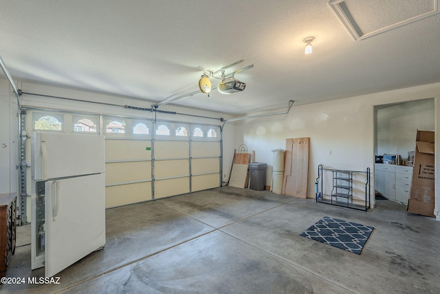 garage with white fridge and a garage door opener