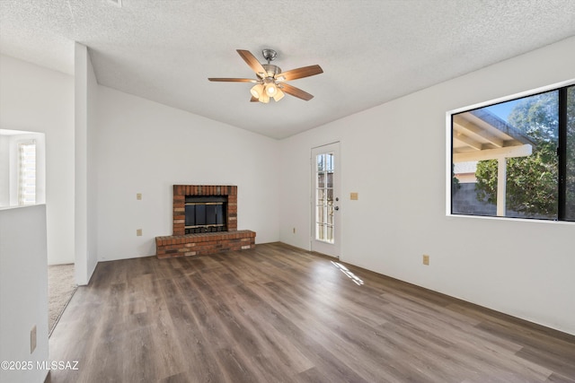 unfurnished living room featuring a wealth of natural light, a textured ceiling, and a fireplace