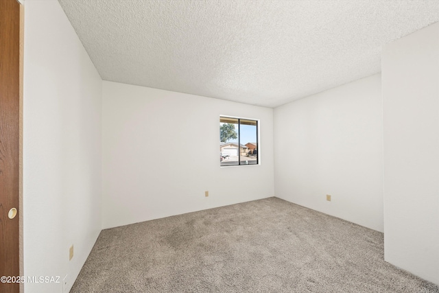 unfurnished room featuring a textured ceiling and carpet flooring