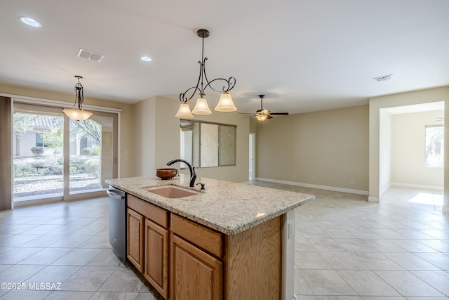 kitchen with hanging light fixtures, dishwasher, sink, and a center island with sink