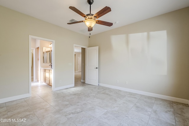 unfurnished bedroom with connected bathroom and ceiling fan