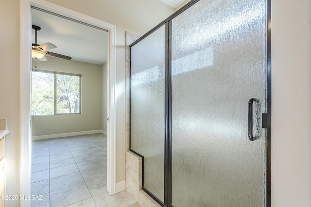 bathroom featuring a shower with door, tile patterned flooring, and ceiling fan