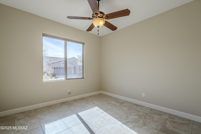 empty room featuring light tile patterned floors and ceiling fan