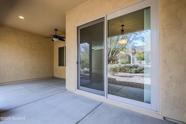 exterior space with ceiling fan