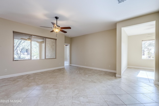 spare room with light tile patterned floors and ceiling fan