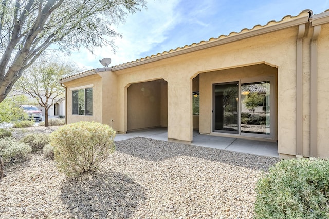 back of property featuring a patio