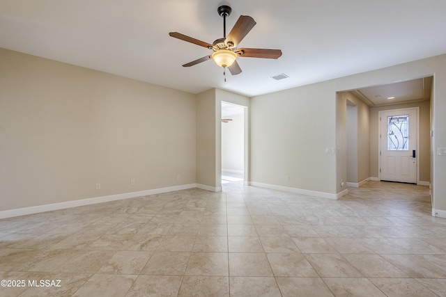 tiled empty room with ceiling fan