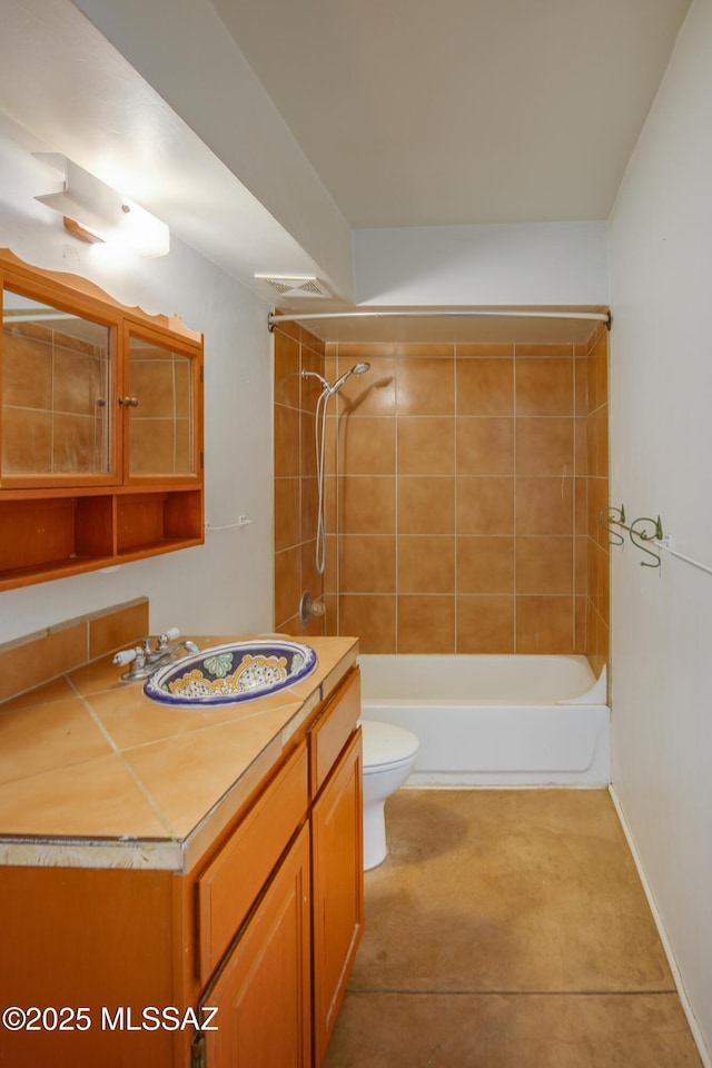 full bathroom featuring tile patterned floors, vanity, toilet, and tiled shower / bath