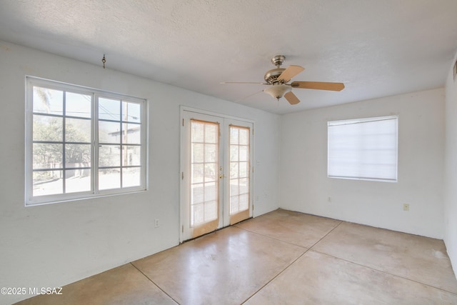 spare room with ceiling fan, french doors, and a textured ceiling