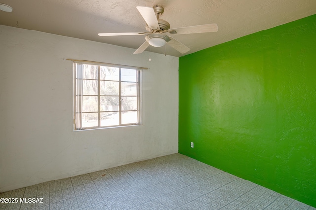 empty room featuring a textured ceiling and ceiling fan