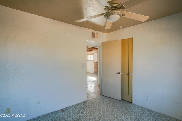 spare room with ceiling fan