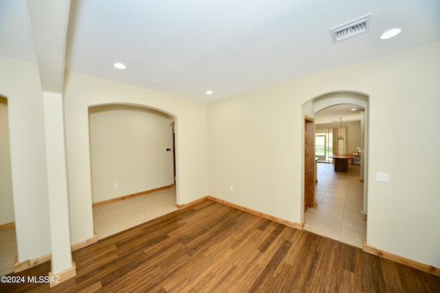 unfurnished room with hardwood / wood-style floors