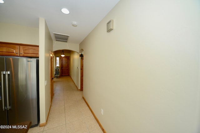 corridor with light tile patterned floors