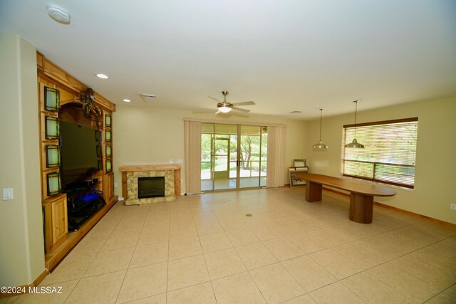 unfurnished living room with ceiling fan and a high end fireplace