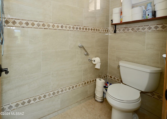 bathroom with tile walls, tile patterned flooring, and toilet