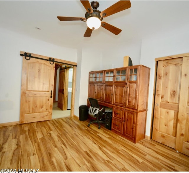 home office with light hardwood / wood-style floors, ceiling fan, and washer / clothes dryer