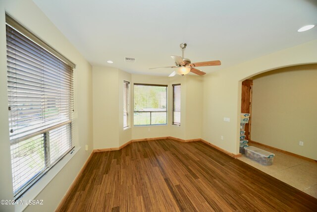 unfurnished living room featuring hardwood / wood-style floors and ceiling fan