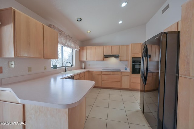 kitchen featuring light tile patterned flooring, vaulted ceiling, black appliances, kitchen peninsula, and light brown cabinets