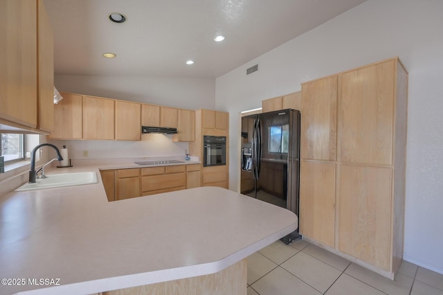 kitchen featuring light brown cabinetry, sink, vaulted ceiling, kitchen peninsula, and black appliances