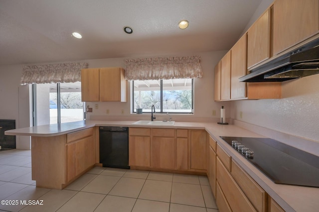 kitchen with sink, black appliances, kitchen peninsula, and light brown cabinets