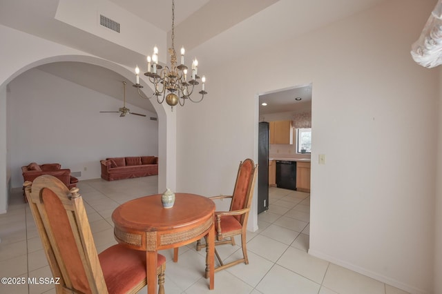 tiled dining space featuring lofted ceiling and ceiling fan