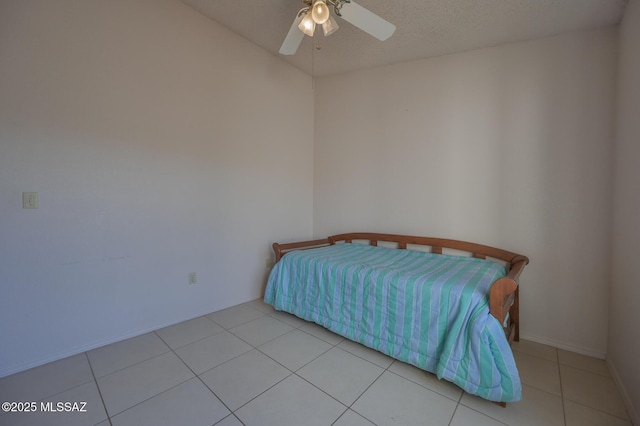 tiled bedroom featuring ceiling fan and a textured ceiling