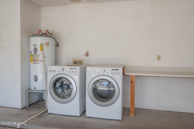 laundry area with washing machine and dryer and water heater