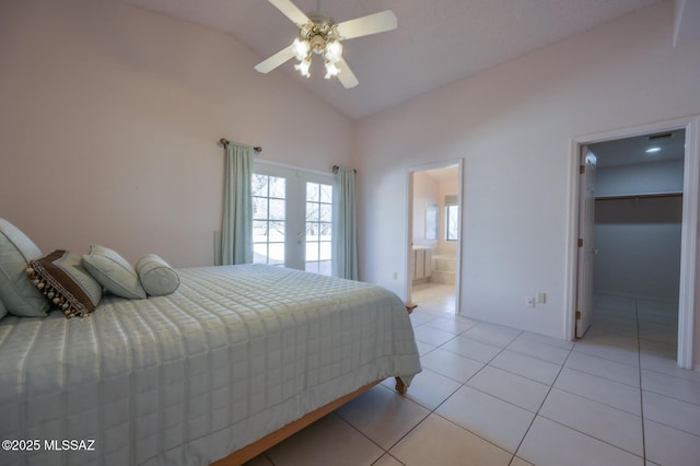 tiled bedroom featuring a walk in closet, ensuite bathroom, lofted ceiling, and ceiling fan