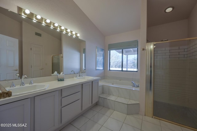 bathroom with lofted ceiling, separate shower and tub, tile patterned flooring, and vanity