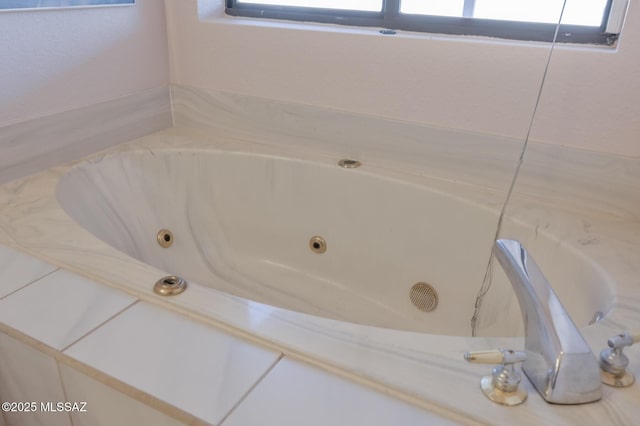 bathroom with a bathing tub and plenty of natural light