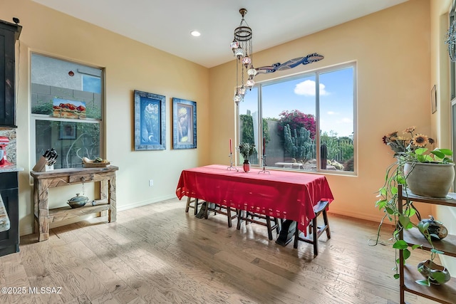 dining space with recessed lighting, wood finished floors, and baseboards