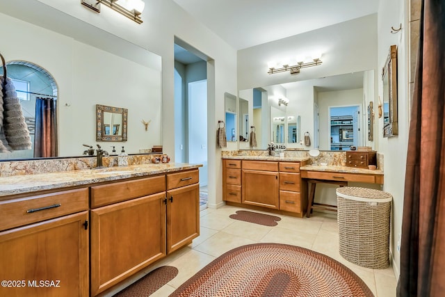 full bath with tile patterned flooring, two vanities, and a sink