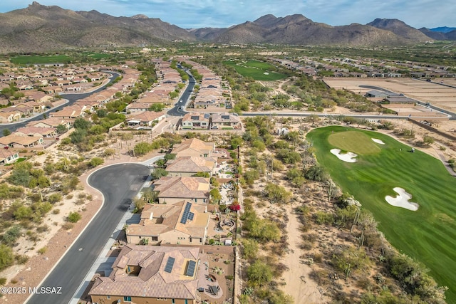 drone / aerial view featuring a residential view, a mountain view, and golf course view