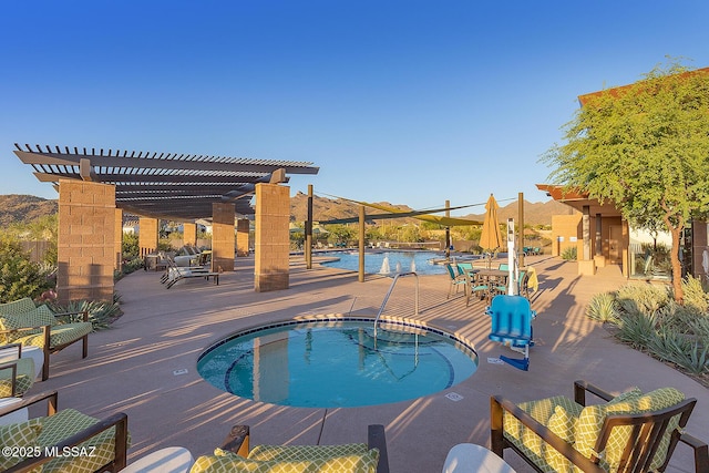 pool with a community hot tub, a water and mountain view, a patio area, and a pergola