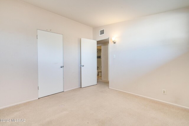 unfurnished bedroom featuring light carpet