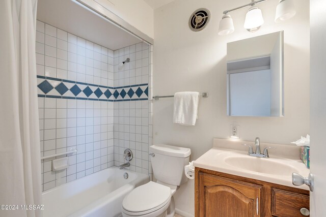 full bathroom with vanity, toilet, and tiled shower / bath combo