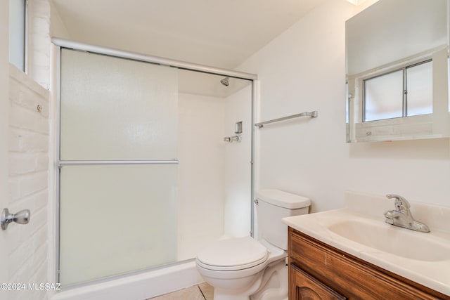 bathroom featuring tile patterned flooring, vanity, toilet, and an enclosed shower