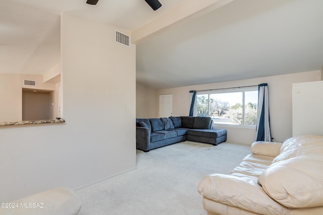 carpeted living room featuring ceiling fan and lofted ceiling