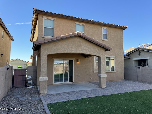 back of property featuring a patio