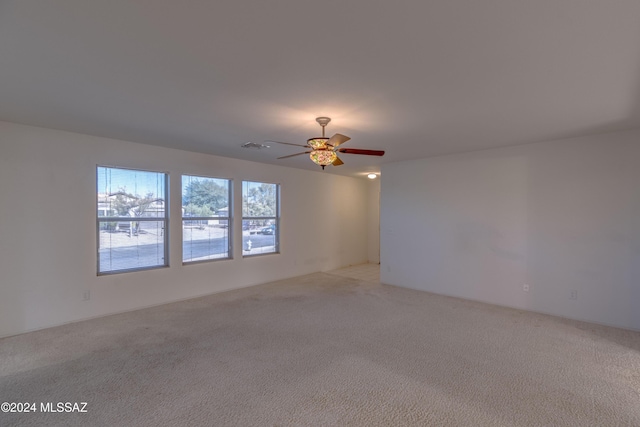 unfurnished room with ceiling fan and light colored carpet