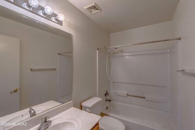 full bathroom with vanity, toilet, shower / bath combination, and a textured ceiling