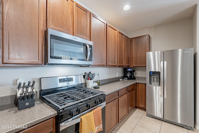 kitchen featuring light tile patterned floors and appliances with stainless steel finishes